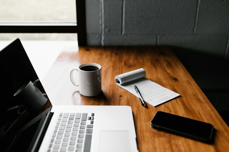 Best AI CRM for small business 2026 — sales workspace with laptop phone and notebook